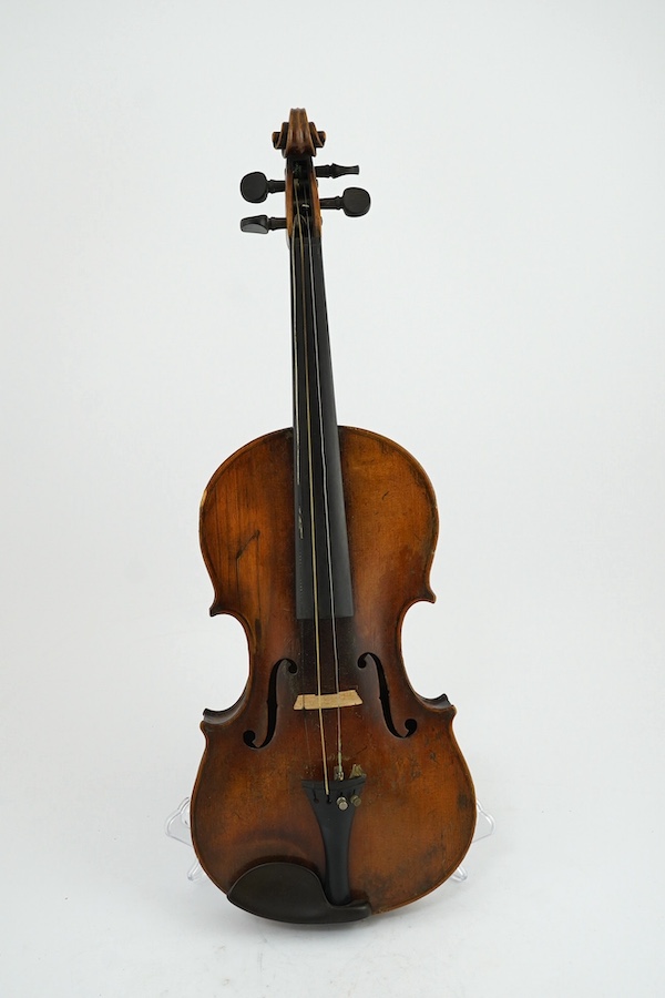 A late 19th century German Nuremberg school violin c.1880, Stradivarius pattern with a finely carved scroll and a large 14.25 inch body, together with a fully mounted German octagonal bow, contained within a contemporary